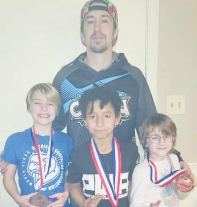 Coach Anthony Fee and his three sons Ashton, Alexander and Ezekial.